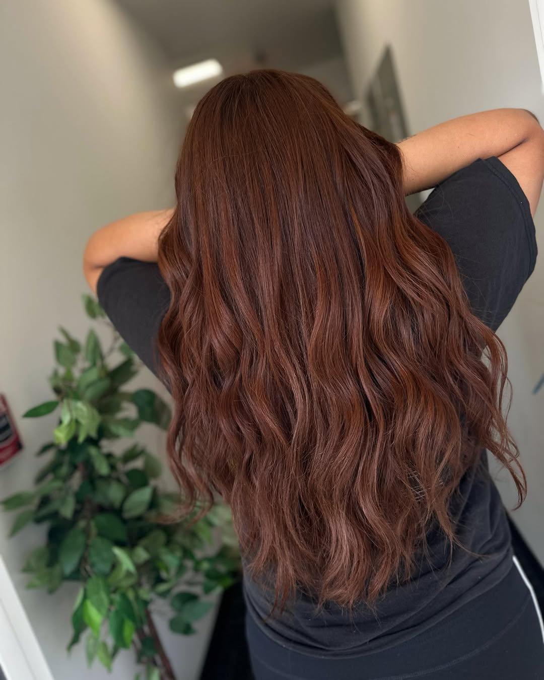 Long auburn red hair styled in loose waves