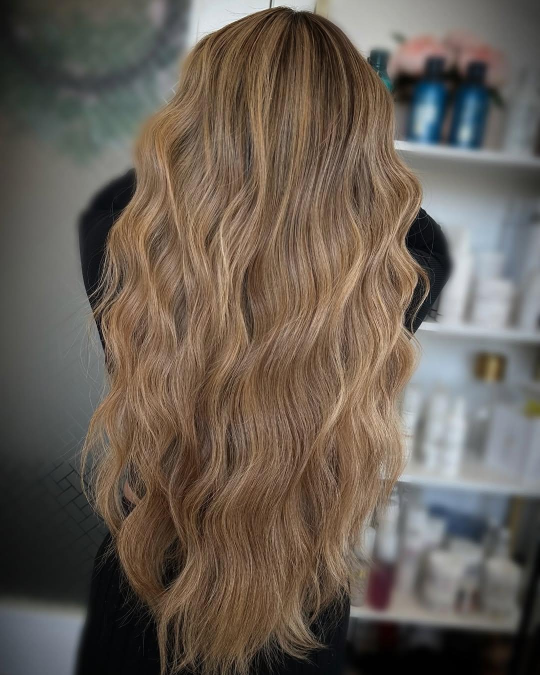 Long golden blonde hair with extensions, waved through the ends