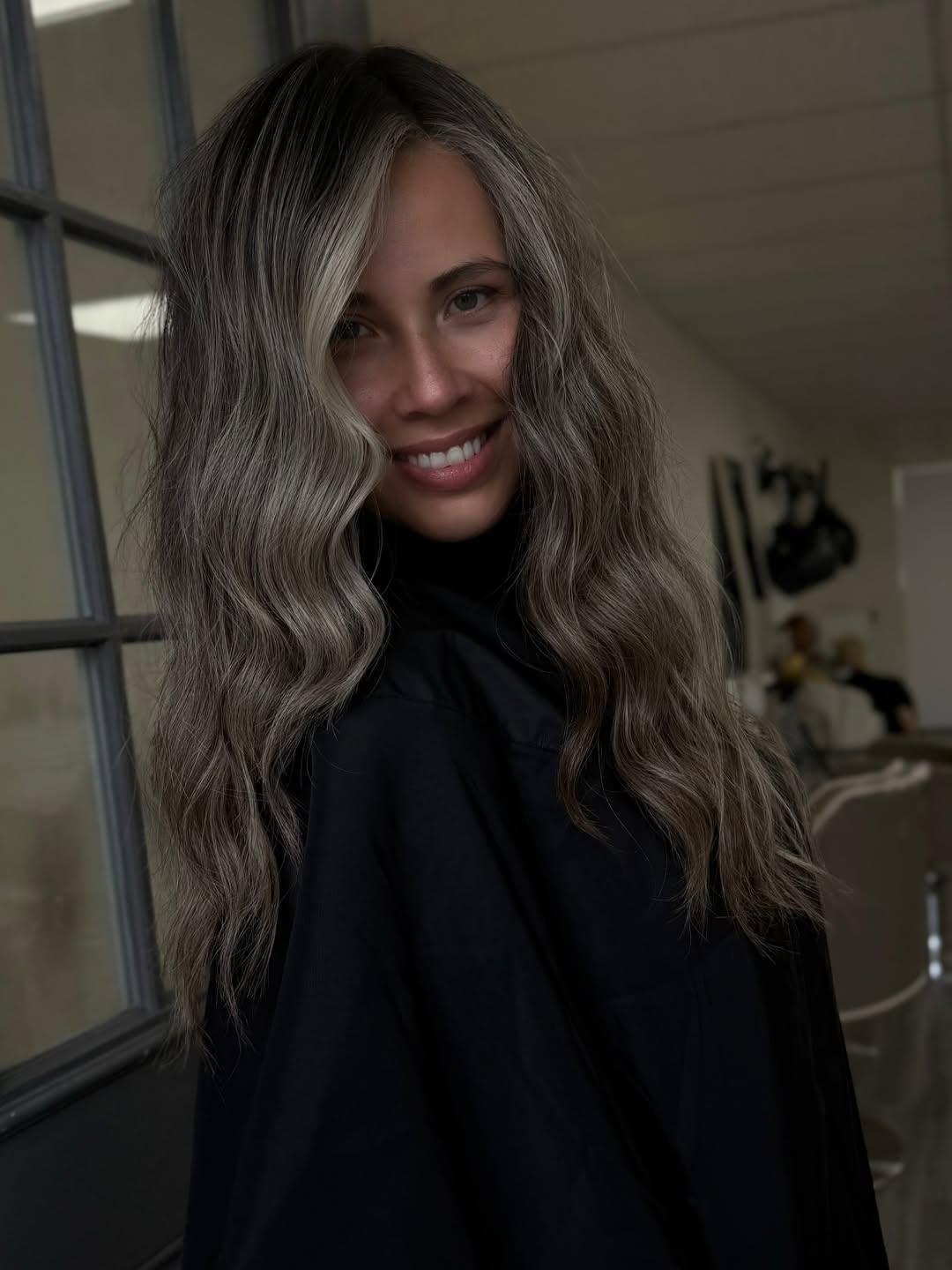 A long colour melt running from a dark root into blonde ends