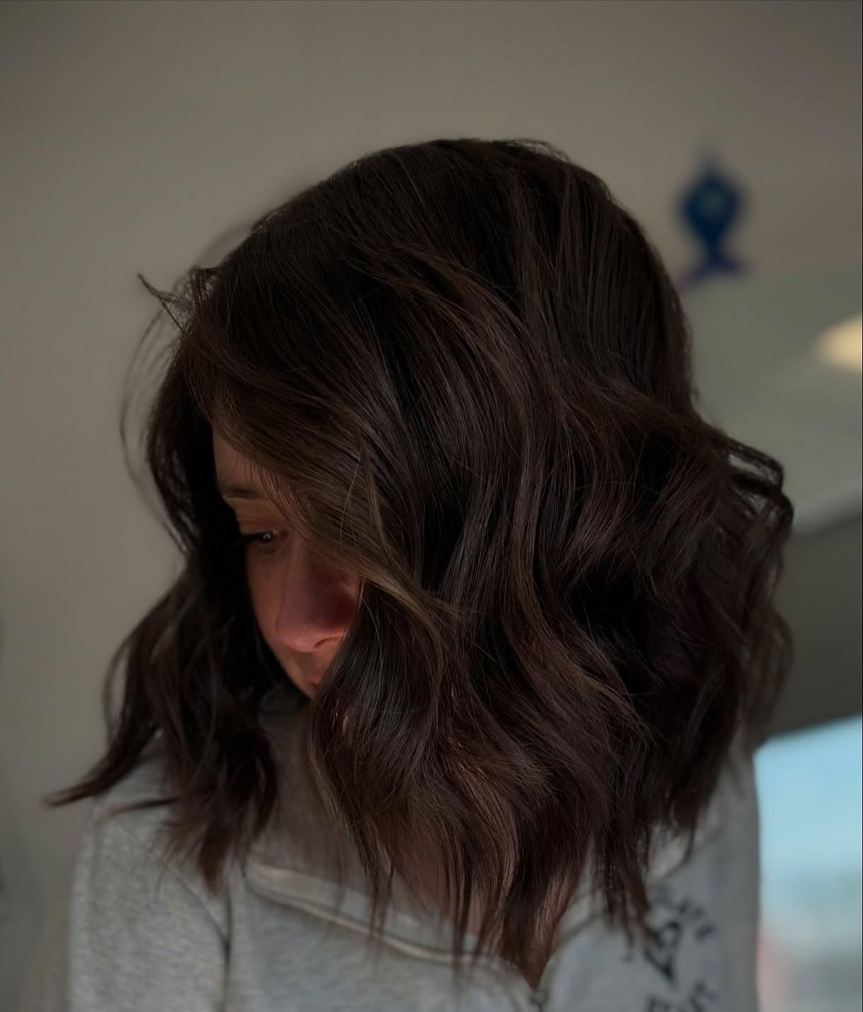 A shoulder-length brunette lob with piecey, textured ends