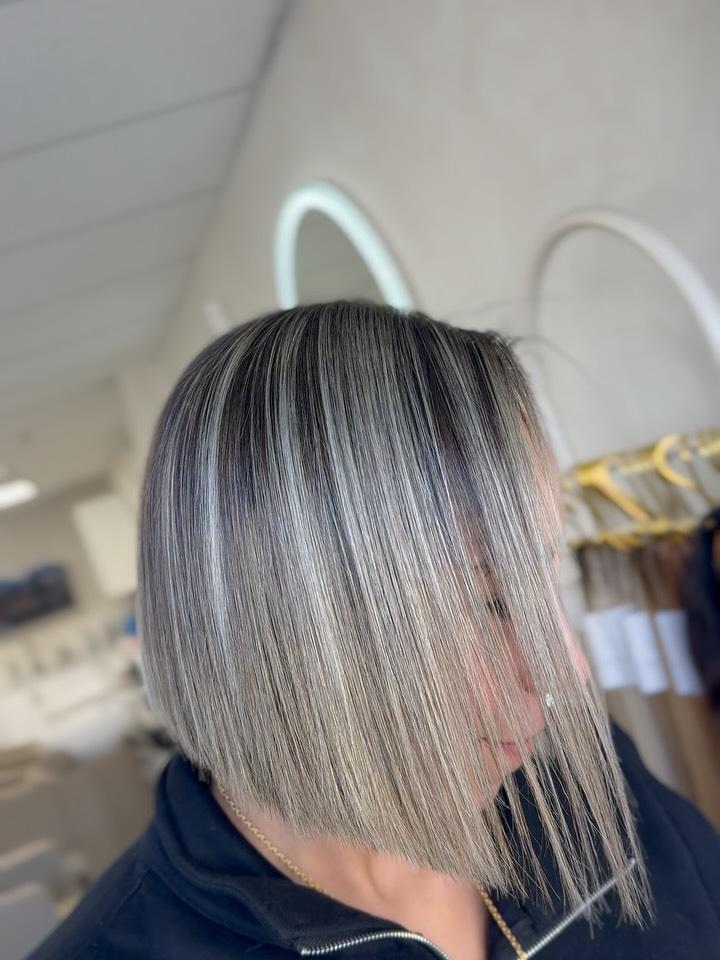 A sharp platinum blonde bob with a dark shadowed root